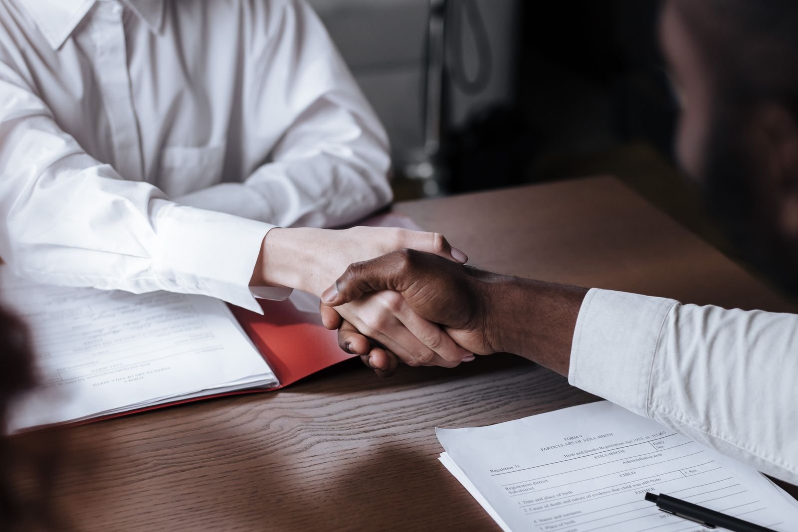 Two partners shaking hands over a distribution agreement